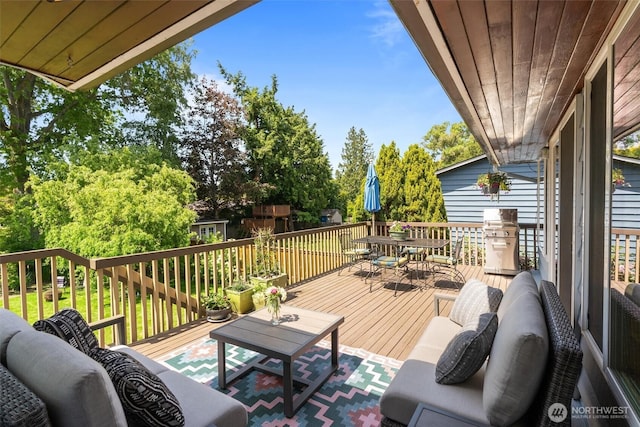 10051 45th Ave NE, Seattle, WA 98125 - wooden terrace featuring outdoor dining area, an outdoor living space, and view of scattered trees