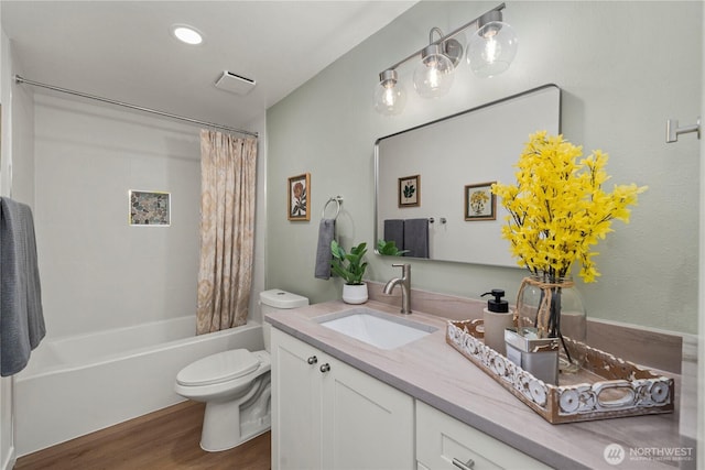 21326 5th Ave S, Des Moines, WA 98198 - full bathroom with wood finished floors, toilet, vanity, and shower / bath combo