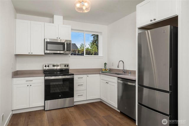 21326 5th Ave S, Des Moines, WA 98198 - kitchen featuring stainless steel appliances, a sink, white cabinets, and dark wood-style flooring