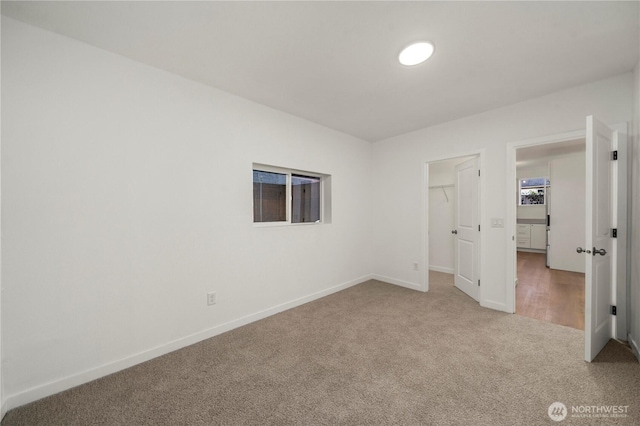 21326 5th Ave S, Des Moines, WA 98198 - unfurnished bedroom featuring carpet floors, baseboards, a spacious closet, and a closet