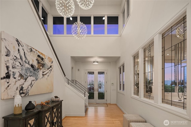 8902 N Mercer Way, Mercer Island, WA 98040 - entrance foyer featuring a chandelier, wood finished floors, french doors, stairs, and baseboards
