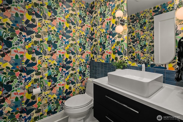 8902 N Mercer Way, Mercer Island, WA 98040 - half bath with wallpapered walls, toilet, vanity, and tasteful backsplash