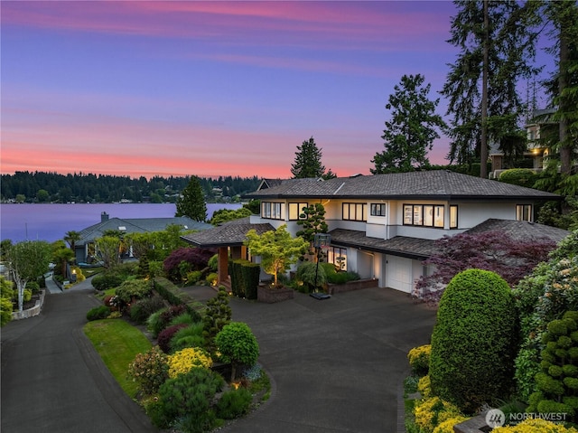 8902 N Mercer Way, Mercer Island, WA 98040 - view of front of house featuring asphalt driveway, stucco siding, and an attached garage