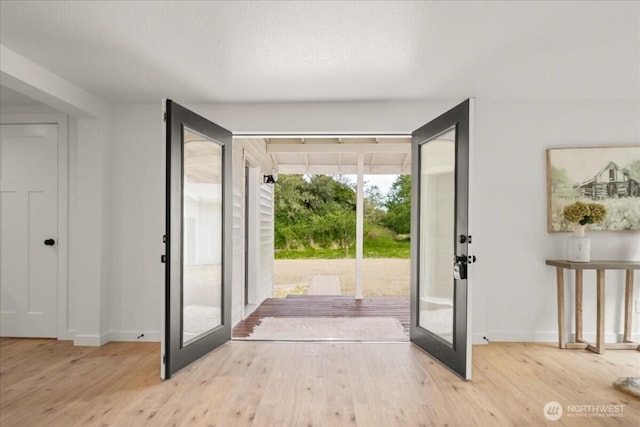 1405 33rd St, Seaview, WA 98644 - entryway with french doors, wood finished floors, and baseboards