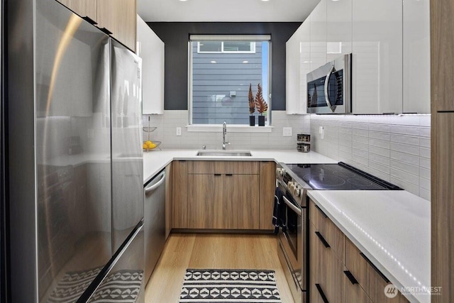 5710 Roosevelt Way NE Unit B, Seattle, WA 98105 - kitchen featuring appliances with stainless steel finishes, a sink, and modern cabinets
