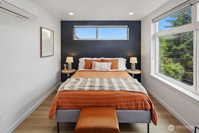 5710 Roosevelt Way NE Unit B, Seattle, WA 98105 - bedroom with a wall mounted AC, baseboards, recessed lighting, and wood finished floors