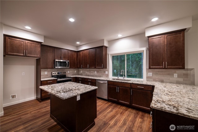 8570 Trillium Ln, Concrete, WA 98237 - kitchen featuring appliances with stainless steel finishes, a sink, light stone countertops, dark brown cabinets, and dark wood finished floors