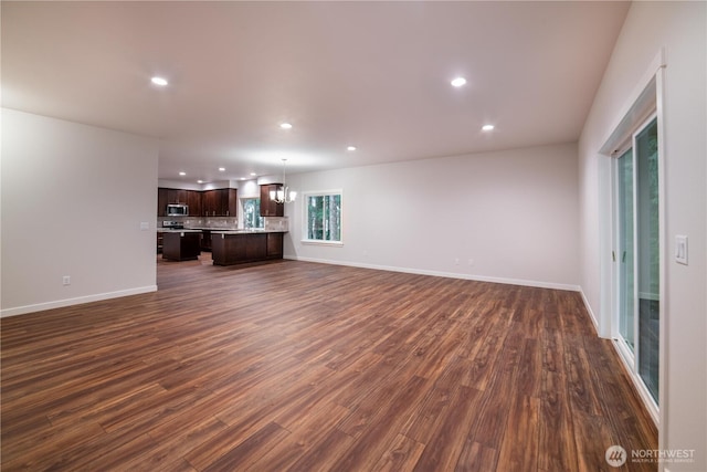 8570 Trillium Ln, Concrete, WA 98237 - unfurnished living room with recessed lighting, dark wood-type flooring, baseboards, and a chandelier