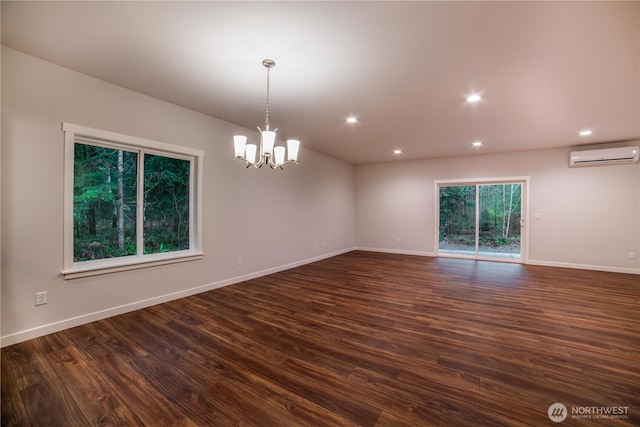 8570 Trillium Ln, Concrete, WA 98237 - spare room with a wall mounted AC, a chandelier, dark wood-style floors, recessed lighting, and baseboards