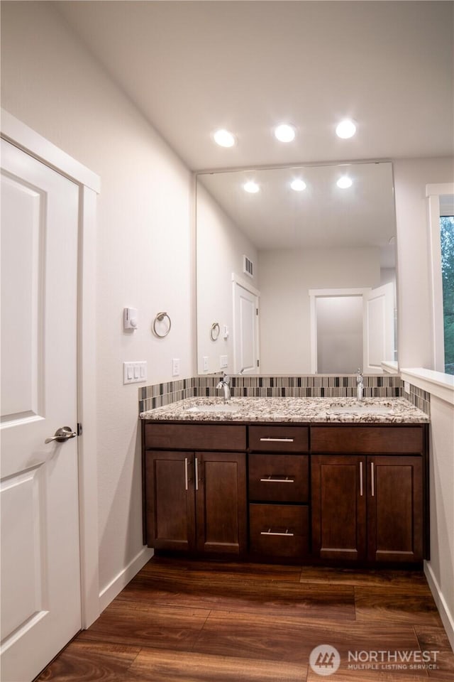 8570 Trillium Ln, Concrete, WA 98237 - full bath with wood finished floors, recessed lighting, double vanity, and baseboards