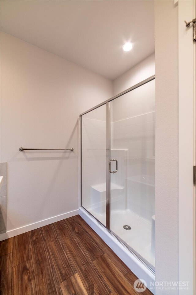 8570 Trillium Ln, Concrete, WA 98237 - bathroom with a stall shower, wood finished floors, and baseboards