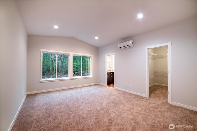 8570 Trillium Ln, Concrete, WA 98237 - unfurnished bedroom with a wall mounted air conditioner, a spacious closet, light colored carpet, baseboards, and lofted ceiling