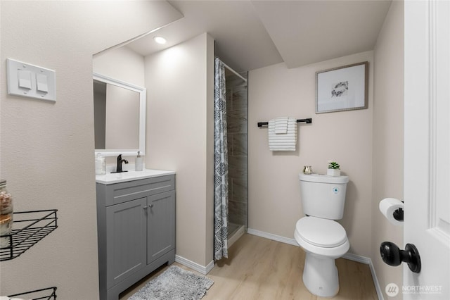 1622 S Mason Ave, Tacoma, WA 98405 - full bathroom featuring toilet, wood finished floors, vanity, tiled shower, and baseboards