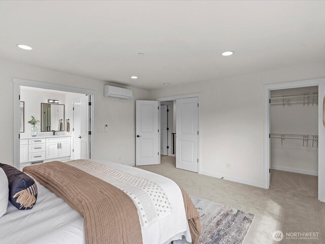 667 17th Ave NW, Issaquah, WA 98027 - bedroom featuring an AC wall unit, light carpet, baseboards, a walk in closet, and recessed lighting