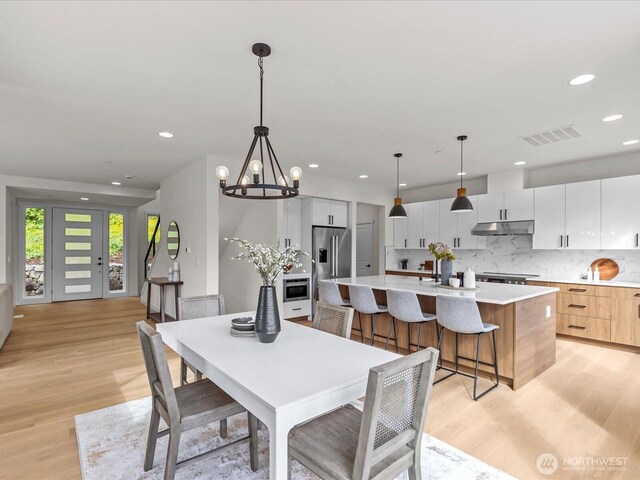 667 17th Ave NW, Issaquah, WA 98027 - dining space with light wood-type flooring, recessed lighting, and a chandelier