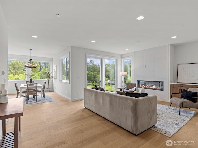 667 17th Ave NW, Issaquah, WA 98027 - living area with light wood-style flooring, baseboards, a fireplace, and recessed lighting