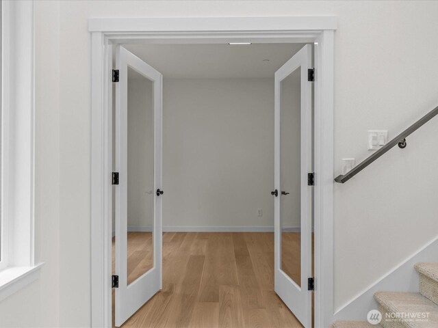 667 17th Ave NW, Issaquah, WA 98027 - hall featuring french doors, light wood-style floors, and stairs