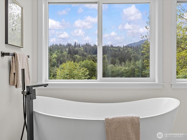 667 17th Ave NW, Issaquah, WA 98027 - bathroom with healthy amount of natural light, a wooded view, and a soaking tub
