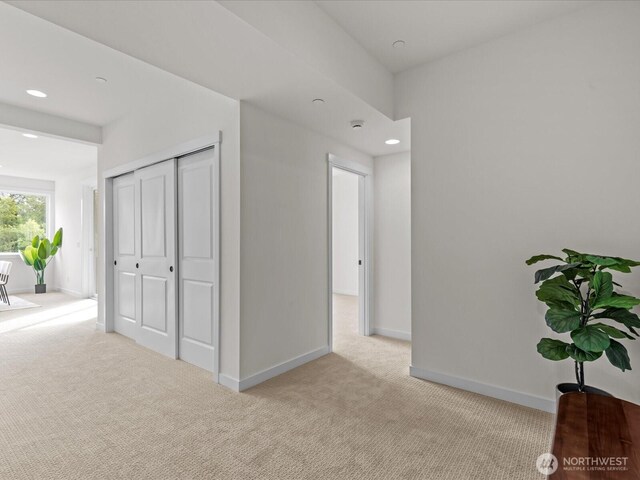 667 17th Ave NW, Issaquah, WA 98027 - unfurnished bedroom with light carpet, baseboards, recessed lighting, and a closet