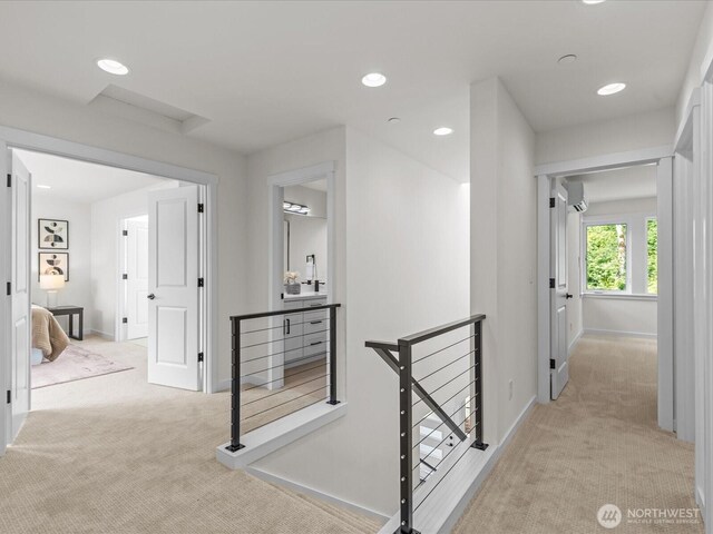 667 17th Ave NW, Issaquah, WA 98027 - hallway with an upstairs landing, light colored carpet, baseboards, recessed lighting, and an AC wall unit
