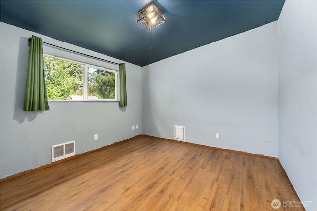 21813 223rd Pl SE, Maple Valley, WA 98038 - empty room with wood finished floors, vaulted ceiling, and baseboards
