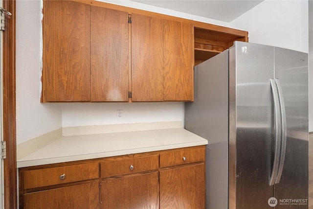 21813 223rd Pl SE, Maple Valley, WA 98038 - kitchen featuring freestanding refrigerator, light countertops, and brown cabinetry