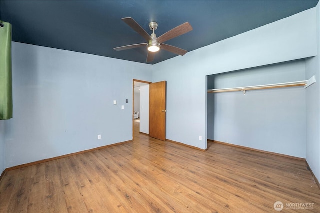 21813 223rd Pl SE, Maple Valley, WA 98038 - unfurnished bedroom featuring wood finished floors, a closet, baseboards, and a ceiling fan