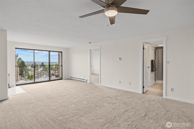 3425 Colby Ave Unit 502, Everett, WA 98201 - spare room featuring baseboard heating, carpet flooring, ceiling fan, baseboards, and a textured ceiling