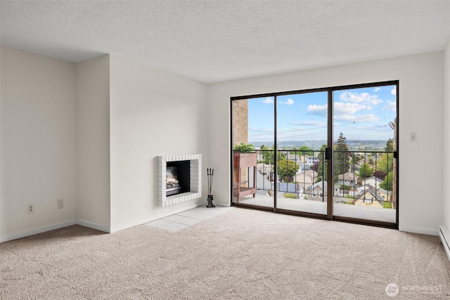 3425 Colby Ave Unit 502, Everett, WA 98201 - unfurnished living room with carpet flooring, baseboards, a textured ceiling, and a fireplace