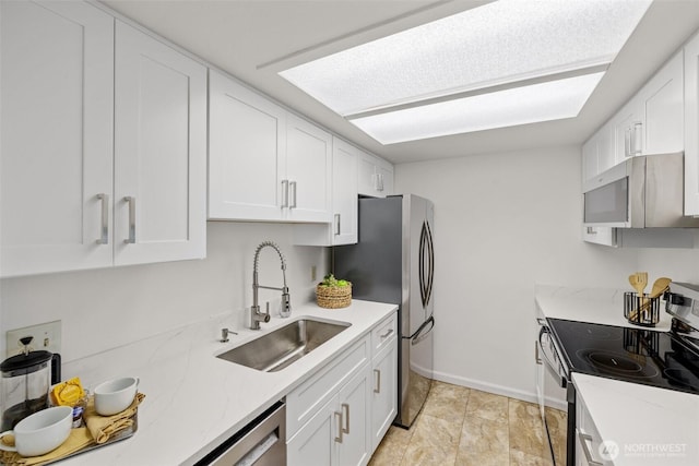 3425 Colby Ave Unit 502, Everett, WA 98201 - kitchen featuring appliances with stainless steel finishes, a sink, white cabinetry, and light stone counters