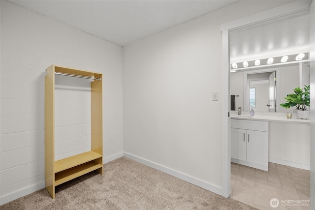 3425 Colby Ave Unit 502, Everett, WA 98201 - unfurnished bedroom with baseboards, a sink, and light carpet
