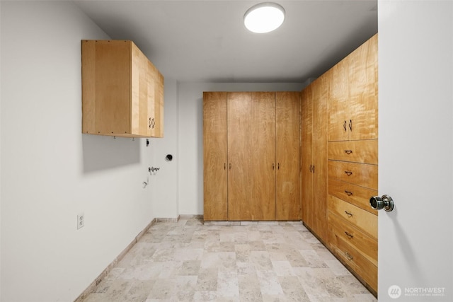 3425 Colby Ave Unit 502, Everett, WA 98201 - washroom featuring cabinet space, baseboards, stone finish flooring, and electric dryer hookup