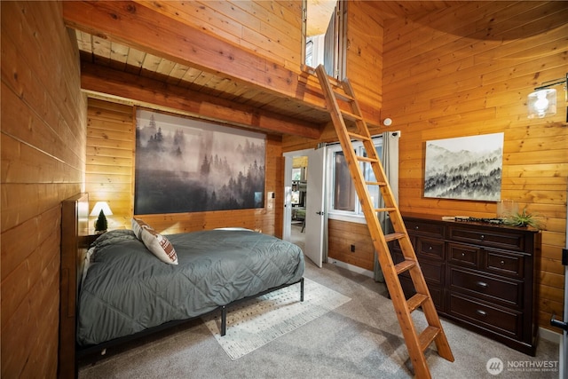 bedroom featuring wood walls, carpet flooring, wooden ceiling, and beamed ceiling