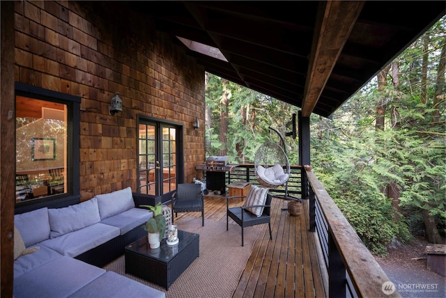 wooden deck featuring an outdoor living space, french doors, and grilling area