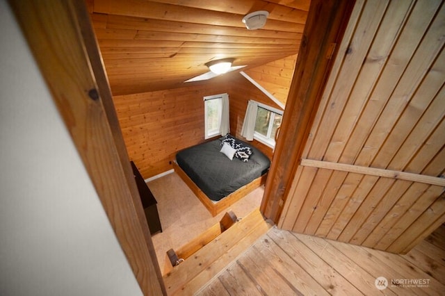bedroom with wooden walls and wooden ceiling