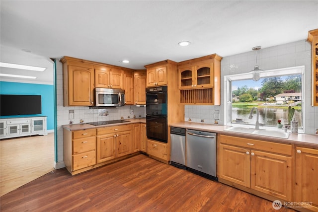 kitchen with black appliances, a sink, dark wood-style floors, backsplash, and recessed lighting