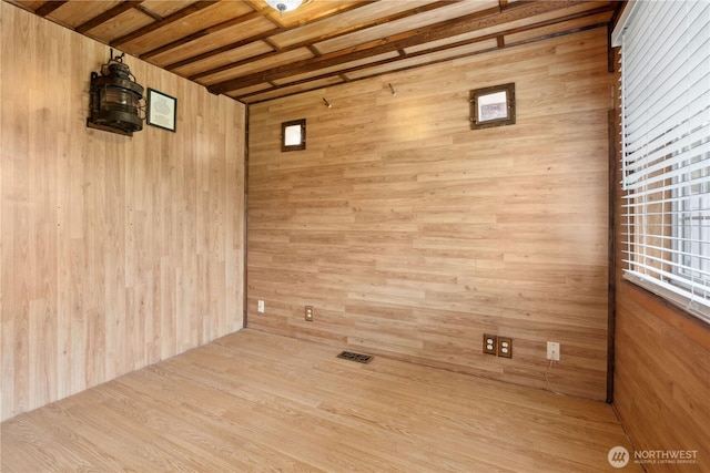 spare room with wood walls