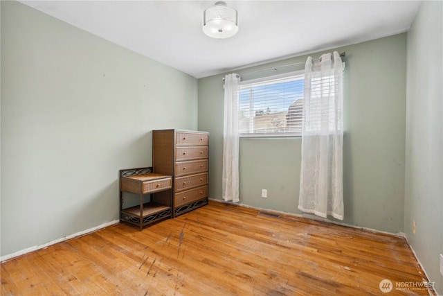 unfurnished bedroom featuring wood finished floors