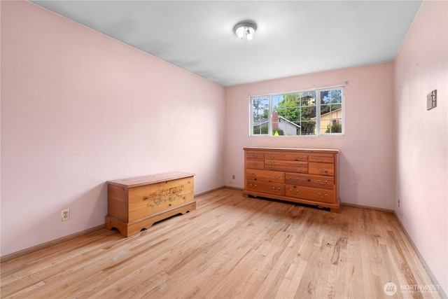 bedroom with wood finished floors and baseboards