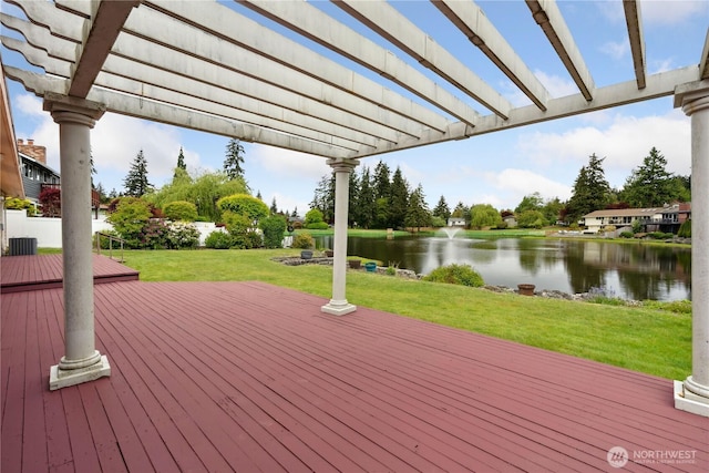 deck featuring a water view and a lawn