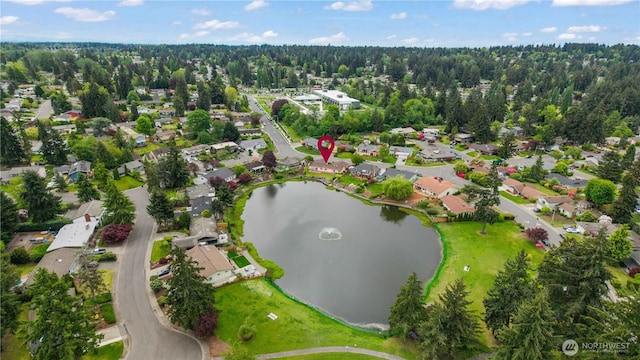 aerial overview of property's location featuring nearby suburban area and a large body of water