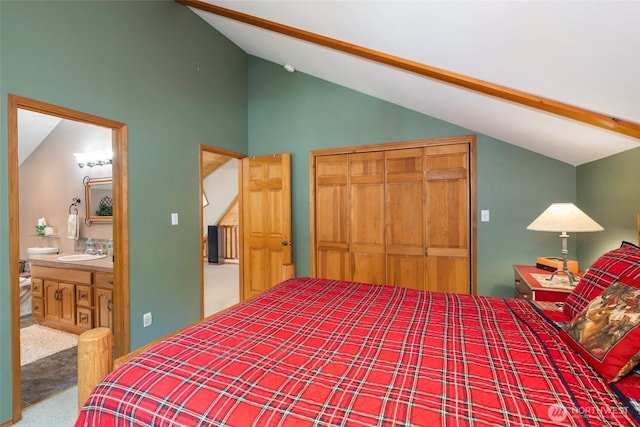 carpeted bedroom with a sink, ensuite bath, a closet, and high vaulted ceiling