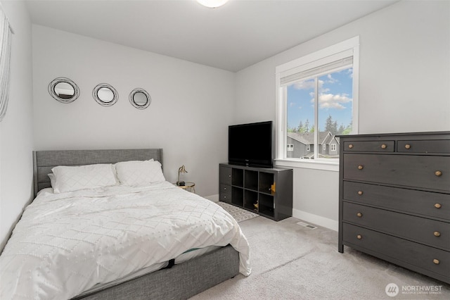 bedroom featuring carpet and baseboards