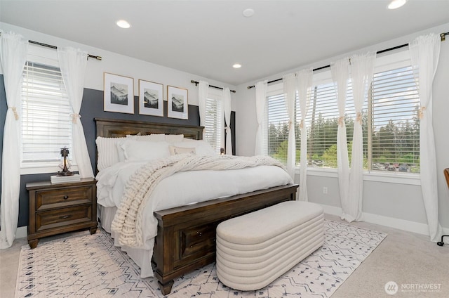 bedroom with baseboards, recessed lighting, and light colored carpet