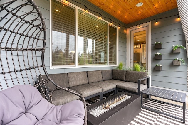 view of patio featuring an outdoor living space with a fire pit