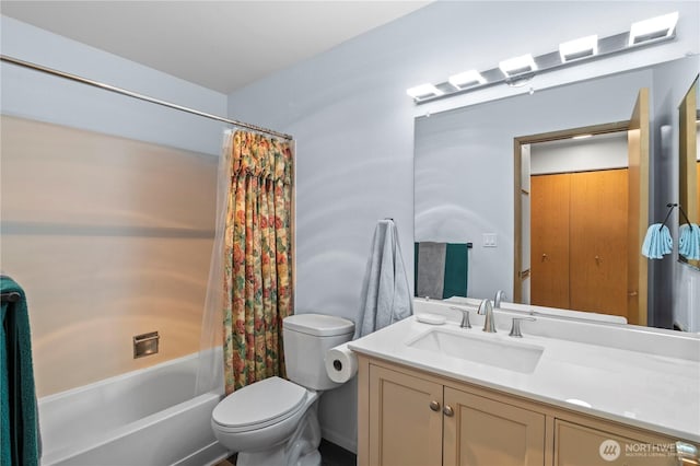 full bath with toilet, vanity, and shower / bath combo