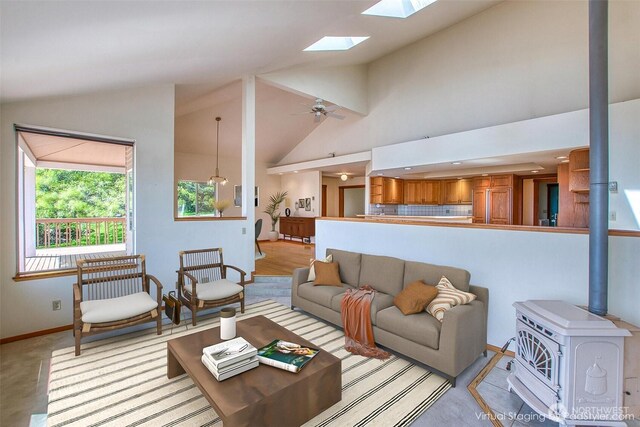 55 Langell Ln, Orcas Island, WA 98245 - living area featuring a wood stove, a skylight, baseboards, and high vaulted ceiling