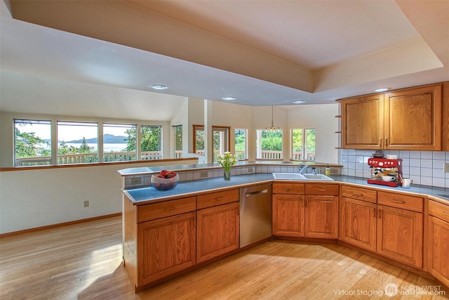 55 Langell Ln, Orcas Island, WA 98245 - kitchen featuring stainless steel dishwasher, light wood-type flooring, a sink, brown cabinets, and recessed lighting