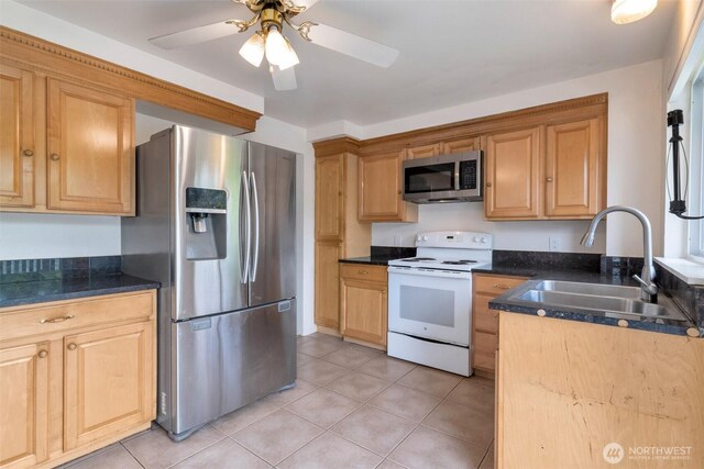 14502 Main St, Bellevue, WA 98007 - kitchen featuring stainless steel appliances, a sink, light tile patterned flooring, and ceiling fan
