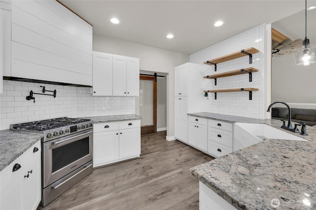 13800 27th Dr NW, Tulalip, WA 98271 - kitchen with gas stove, a sink, backsplash, open shelves, and light stone counters